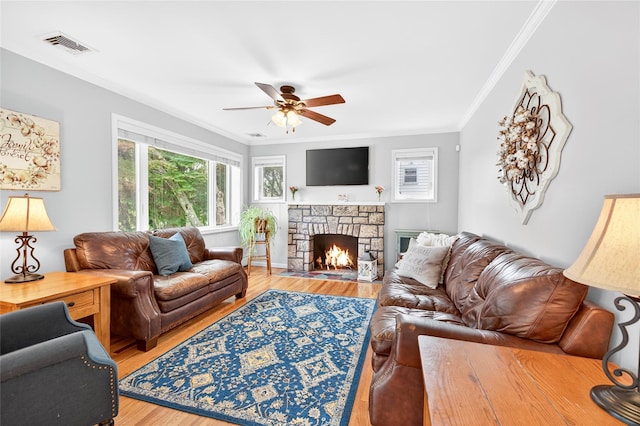 85 Jay St, Stony Point, NY 10980 - living area with crown molding, a ceiling fan, light wood-style floors, and a stone fireplace