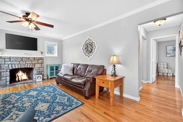 85 Jay St, Stony Point, NY 10980 - living area with light wood-style flooring, ceiling fan, crown molding, and a stone fireplace