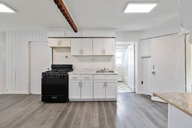 33 N Rte 303, Congers, NY 10920 - kitchen featuring black gas range oven, light wood-style floors, light countertops, and white cabinets