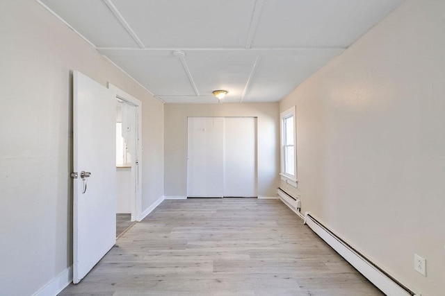 33 N Rte 303, Congers, NY 10920 - unfurnished bedroom with a baseboard radiator, light wood-style flooring, and a closet