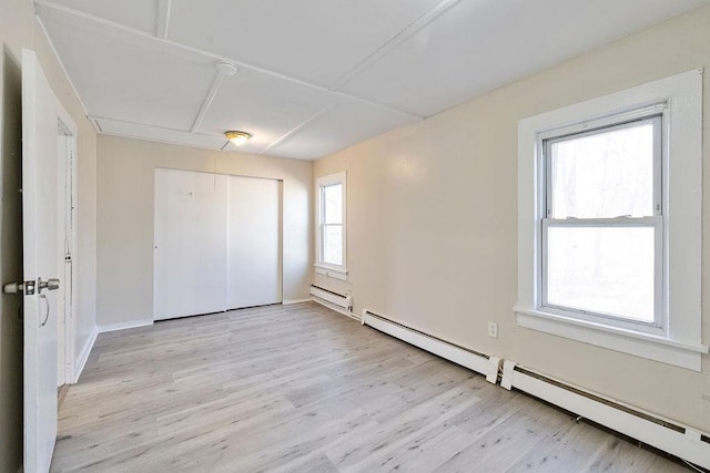 33 N Rte 303, Congers, NY 10920 - unfurnished bedroom featuring a baseboard heating unit, attic access, light wood-type flooring, and a closet