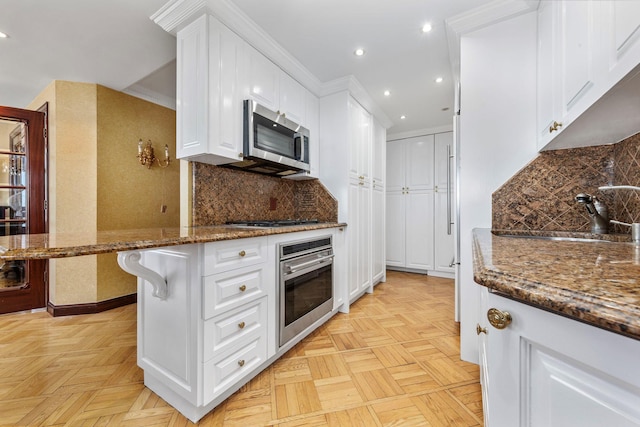 11201 Queens Blvd Unit 10B, Forest Hills, NY 11375 - kitchen featuring stainless steel appliances, white cabinetry, recessed lighting, stone countertops, and tasteful backsplash