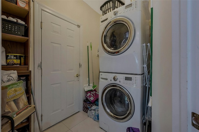 26 Sesame St, Kings Park, NY 11754 - laundry room with stacked washer / dryer and light tile patterned floors