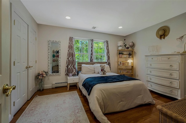 26 Sesame St, Kings Park, NY 11754 - bedroom featuring baseboard heating, dark wood-style floors, and recessed lighting