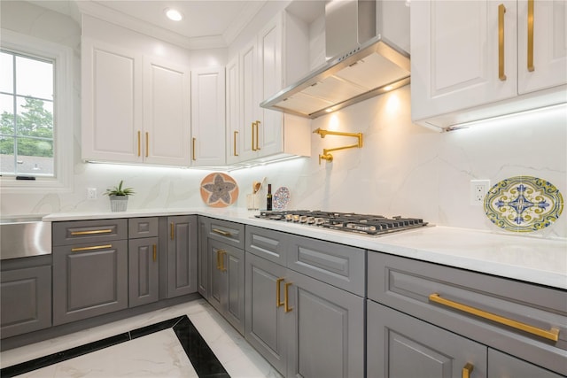 52 Cortland Ave, Hicksville, NY 11801 - kitchen with gray cabinetry, wall chimney range hood, light marble finish flooring, white cabinets, and stainless steel gas cooktop