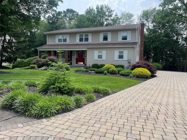 7 Woodland Ter, Orangeburg, NY 10962 - view of front of home featuring a porch, a front yard, and a chimney