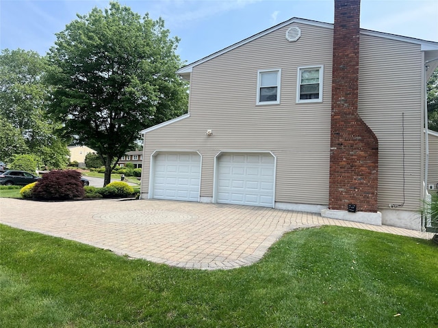 7 Woodland Ter, Orangeburg, NY 10962 - view of side of property featuring an attached garage, a chimney, driveway, and a yard