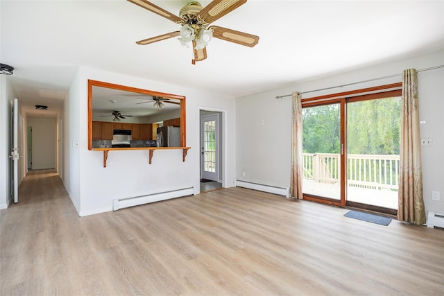 16 Bushwick Rd, Poughkeepsie, NY 12603 - unfurnished living room with baseboard heating, a baseboard radiator, ceiling fan, light wood-style floors, and healthy amount of natural light