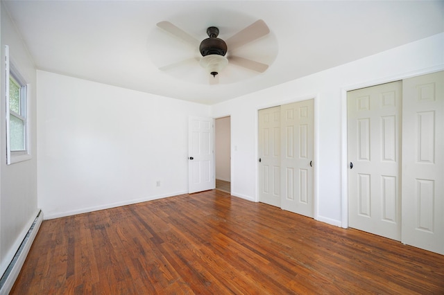 16 Bushwick Rd, Poughkeepsie, NY 12603 - unfurnished bedroom with baseboard heating, multiple closets, wood finished floors, and a ceiling fan