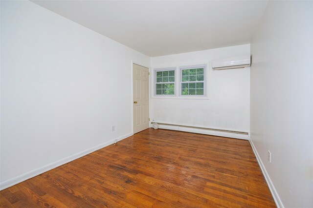 16 Bushwick Rd, Poughkeepsie, NY 12603 - spare room with a baseboard radiator, a wall mounted AC, and wood finished floors