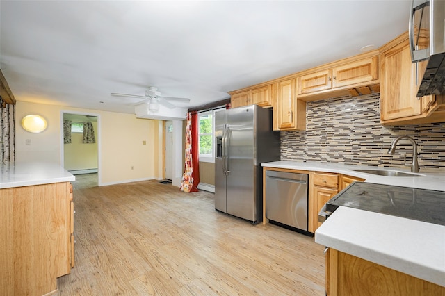 16 Bushwick Rd, Poughkeepsie, NY 12603 - kitchen with stainless steel appliances, light wood finished floors, backsplash, ceiling fan, and light countertops