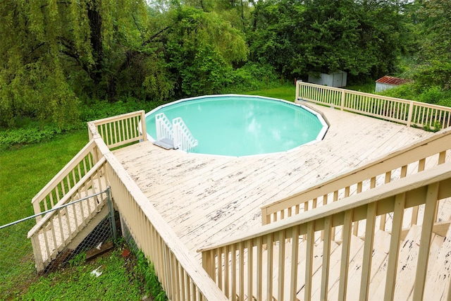 16 Bushwick Rd, Poughkeepsie, NY 12603 - swimming pool featuring a wooden deck, a storage shed, and a lawn