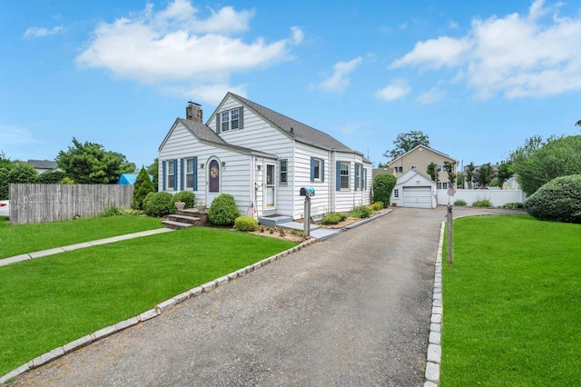 29 E St, Hicksville, NY 11801 - bungalow featuring asphalt driveway, a chimney, an outbuilding, and a detached garage