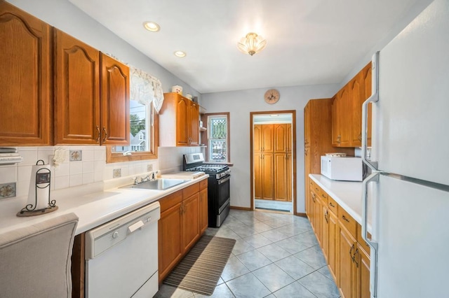 29 E St, Hicksville, NY 11801 - kitchen with white appliances, light countertops, backsplash, recessed lighting, and brown cabinetry