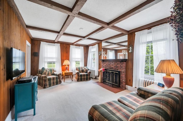 29 E St, Hicksville, NY 11801 - carpeted living area featuring wood walls, coffered ceiling, beam ceiling, a brick fireplace, and radiator heating unit