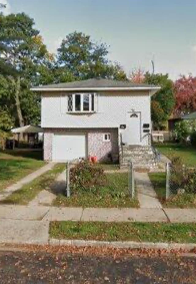 254 Brook St, New Castle, NY 11590 - view of front of property featuring a garage and driveway