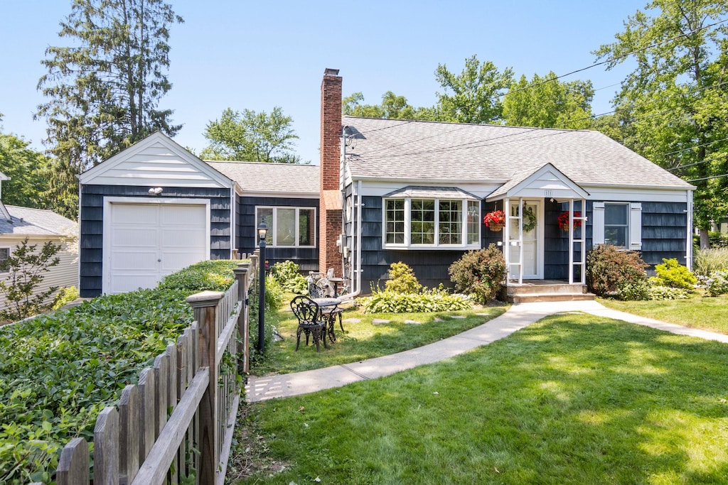 11 Linda Pl, Huntington, NY 11743 - view of front of house featuring a chimney, a garage, and roof with shingles