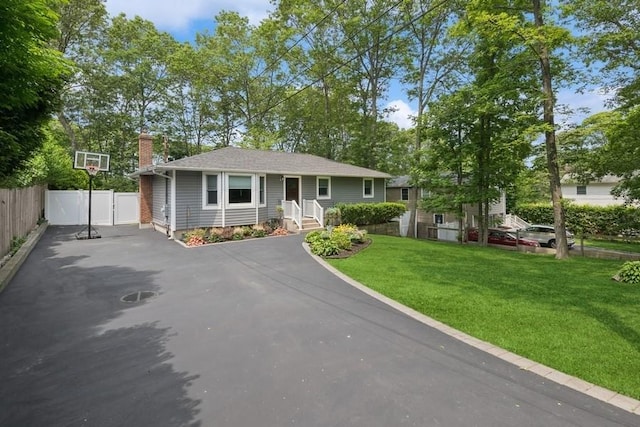 185 Carlton Dr E, Shirley, NY 11967 - view of front facade featuring driveway and a chimney
