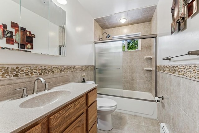 185 Carlton Dr E, Shirley, NY 11967 - bathroom featuring tile walls, vanity, combined bath / shower with glass door, wainscoting, and tile patterned floors