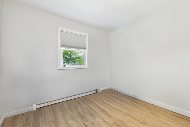 185 Carlton Dr E, Shirley, NY 11967 - unfurnished room with a baseboard heating unit and wood finished floors