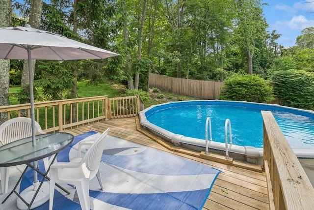185 Carlton Dr E, Shirley, NY 11967 - view of swimming pool featuring a wooden deck and view of scattered trees