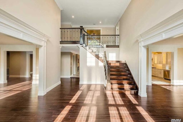 19 Meadow Glen Rd, Fort Salonga, NY 11768 - stairway with wood finished floors, a towering ceiling, and crown molding