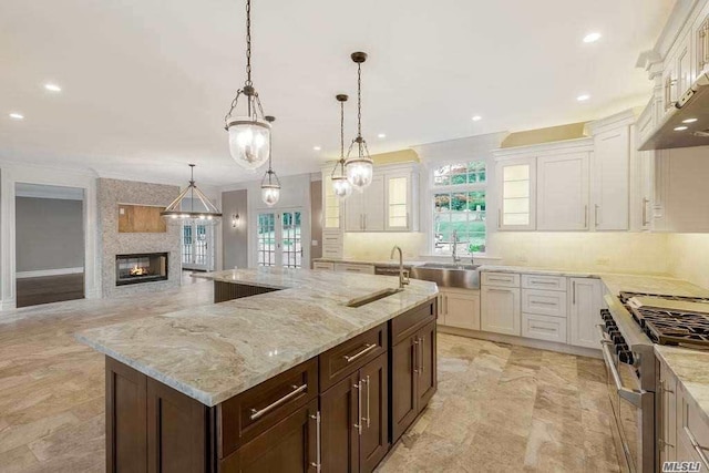 19 Meadow Glen Rd, Fort Salonga, NY 11768 - kitchen featuring double oven range, a fireplace, white cabinetry, light stone counters, and recessed lighting