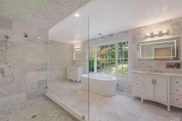 19 Meadow Glen Rd, Fort Salonga, NY 11768 - bathroom with walk in shower, vanity, a soaking tub, tile walls, and marble look tile flooring