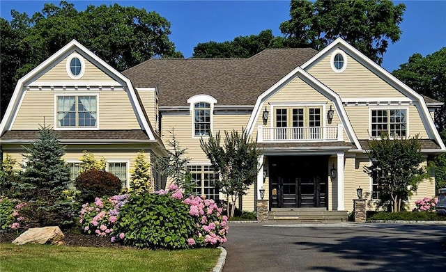 19 Meadow Glen Rd, Fort Salonga, NY 11768 - shingle-style home featuring a gambrel roof, a balcony, and roof with shingles