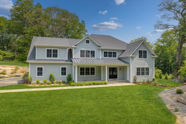 63 Buckout Rd, West Harrison, NY 10604 - view of front facade with a porch, a standing seam roof, a front lawn, board and batten siding, and a metal roof