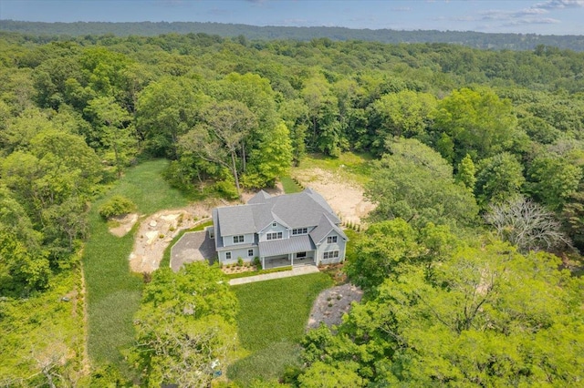 63 Buckout Rd, West Harrison, NY 10604 - aerial view of property and surrounding area featuring a heavily wooded area