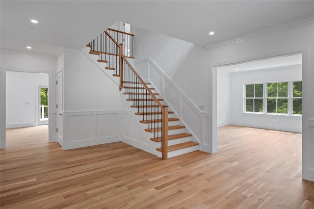 63 Buckout Rd, West Harrison, NY 10604 - stairway featuring ornamental molding, plenty of natural light, wood finished floors, a decorative wall, and recessed lighting