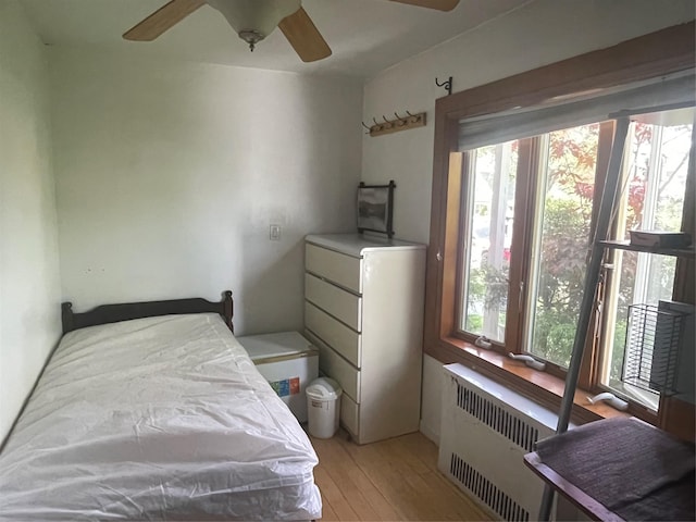 24580 61st Ave Unit 68Th, Little Neck, NY 11362 - bedroom with radiator, light wood-type flooring, and a ceiling fan