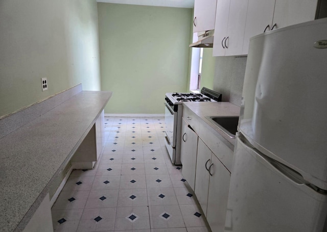6393 Woodhaven Blvd Unit 2F, Rego Park, NY 11374 - kitchen with white appliances, under cabinet range hood, white cabinets, light countertops, and light floors