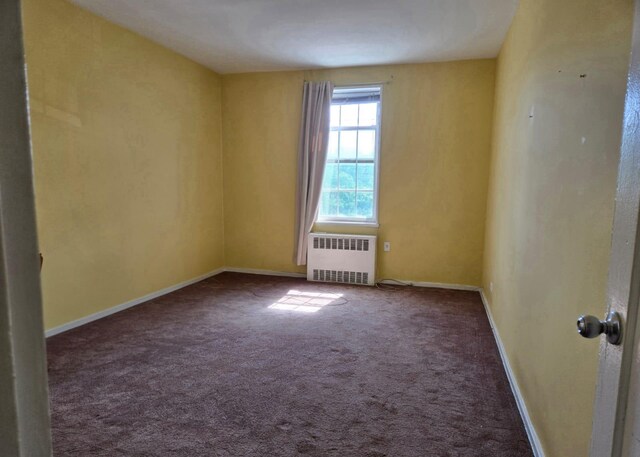 6393 Woodhaven Blvd Unit 2F, Rego Park, NY 11374 - spare room featuring radiator heating unit and carpet floors