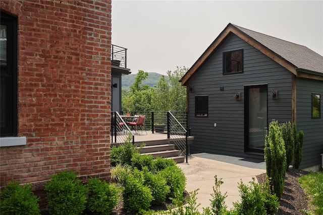 20 Paye Ave, Beacon, NY 12508 - back of house with brick siding, a balcony, a deck with mountain view, and a patio area
