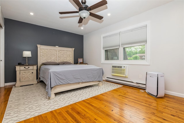 1 Germonds Vlg Unit 16, Bardonia, NY 10954 - bedroom featuring baseboard heating, hardwood / wood-style floors, a wall mounted air conditioner, recessed lighting, and a ceiling fan