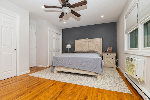 1 Germonds Vlg Unit 16, Bardonia, NY 10954 - bedroom with a baseboard radiator, wood finished floors, recessed lighting, a closet, and an AC wall unit