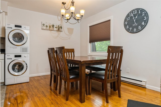 1 Germonds Vlg Unit 16, Bardonia, NY 10954 - dining space featuring stacked washer / drying machine, baseboard heating, a chandelier, and light wood finished floors