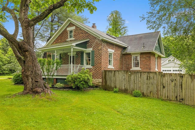 342-344 Van Wagner Rd, Poughkeepsie, NY 12603 - back of property with brick siding, a chimney, covered porch, and roof with shingles