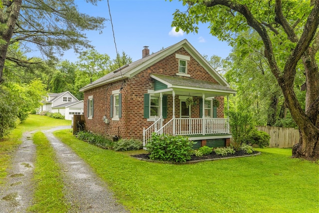 342-344 Van Wagner Rd, Poughkeepsie, NY 12603 - view of front of home with covered porch, brick siding, a chimney, and driveway