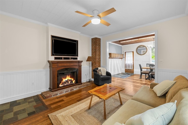 342-344 Van Wagner Rd, Poughkeepsie, NY 12603 - living room with wainscoting, wood finished floors, ornamental molding, a lit fireplace, and a ceiling fan