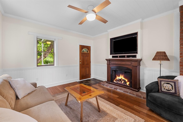 342-344 Van Wagner Rd, Poughkeepsie, NY 12603 - living room with wood finished floors, a lit fireplace, wainscoting, ceiling fan, and crown molding