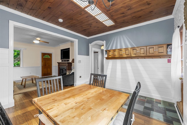 342-344 Van Wagner Rd, Poughkeepsie, NY 12603 - dining space with a fireplace, a wainscoted wall, ornamental molding, arched walkways, and dark wood finished floors
