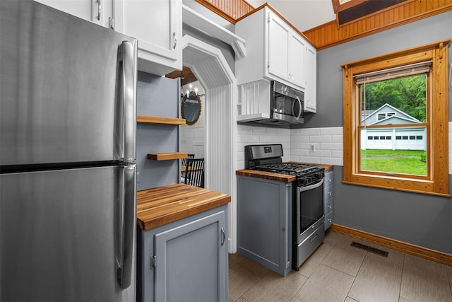 342-344 Van Wagner Rd, Poughkeepsie, NY 12603 - kitchen featuring stainless steel appliances, wooden counters, open shelves, backsplash, and white cabinetry
