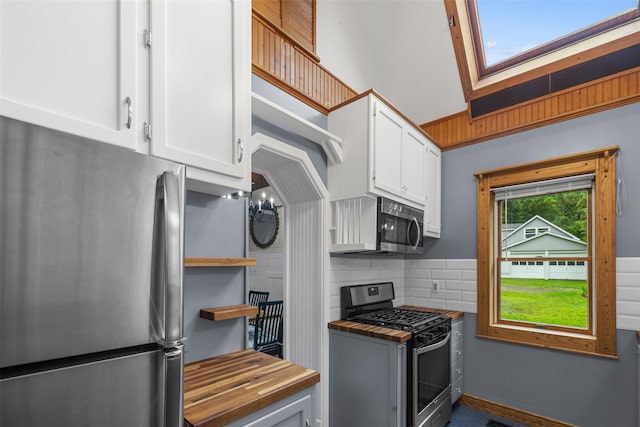 342-344 Van Wagner Rd, Poughkeepsie, NY 12603 - kitchen with stainless steel appliances, butcher block counters, white cabinetry, decorative backsplash, and open shelves