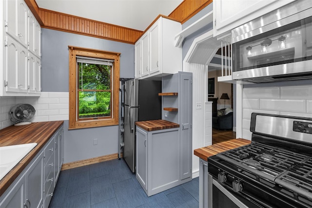 342-344 Van Wagner Rd, Poughkeepsie, NY 12603 - kitchen featuring appliances with stainless steel finishes, butcher block counters, tasteful backsplash, and white cabinets
