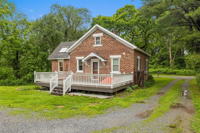 342-344 Van Wagner Rd, Poughkeepsie, NY 12603 - view of front of house featuring a chimney, brick siding, a wooden deck, and a front yard
