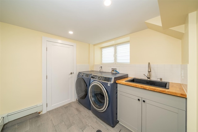 79 Fern St, New Rochelle, NY 10801 - laundry room featuring a baseboard heating unit, separate washer and dryer, light wood-style floors, cabinet space, and recessed lighting