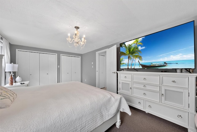 11 Beverly Ln, Peekskill, NY 10566 - bedroom with a chandelier, two closets, and dark carpet
